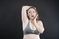 Unhappy woman shows her unshaved armpit. plus size middle age woman is not happy with hair in her armpits. Caucasian girl is Royalty Free Stock Photo