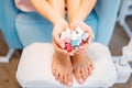 Woman shows many varnish bottles in beauty shop