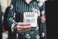 Woman shows notepad with the text gender equality