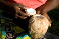 Woman shows opened coconut.