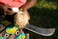 Woman shows opened coconut.