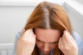 Woman shows regrown hair roots. long dyed hair, growing natural color. gray