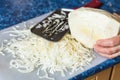 Woman shreds cabbage on cutting board Royalty Free Stock Photo