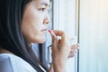 Woman sick with capsules putting in her mouth,female taking medicines and a glass of water,Concept for health Royalty Free Stock Photo