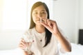 Woman sick with capsules putting in her mouth,female taking medicines and a glass of water Royalty Free Stock Photo