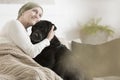 Sick woman hugging her pet Royalty Free Stock Photo