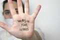 Woman on a side wearing a safety mask with hand opened with the sentence