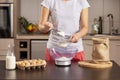 Woman sieving and measuring flour Royalty Free Stock Photo