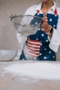 Woman sifting flour through sieve. Selective focus. Royalty Free Stock Photo