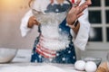 Woman sifting flour through sieve. Selective focus. Royalty Free Stock Photo
