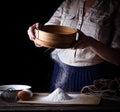 Woman sifting flour through sieve Royalty Free Stock Photo