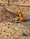 Woman Sifting Sand