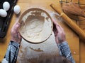 A woman sifts flour in a sieve on a kitchen cutting Board.Home cooking