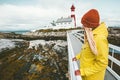 Woman sightseeing Norway lighthouse landscape