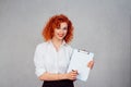 Woman, sign here. Portrait closeup beautiful young business girl secretary white shirt red head looking at you camera showing Royalty Free Stock Photo