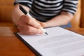 Woman signature document and sitting behind desk