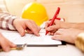 Woman signing construction contract with contractor to build a house Royalty Free Stock Photo