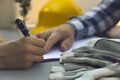 Woman signing construction contract with contractor. Yellow helm Royalty Free Stock Photo