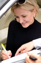 Woman signing a deal to purchase a car