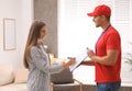 Woman signing for delivered parcels. Courier service Royalty Free Stock Photo