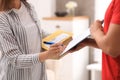 Woman signing for delivered parcels at home, closeup Royalty Free Stock Photo