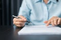 Woman signing document, focus on female hand holding pen, putting signature at official paper. Close up businesswoman signing Royalty Free Stock Photo