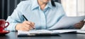 Woman signing document, focus on female hand holding pen, putting signature at official paper. Close up businesswoman signing Royalty Free Stock Photo