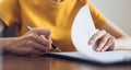 Woman signing document and hand holding pen putting signature at paper, order to authorize their rights. Royalty Free Stock Photo