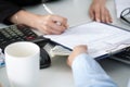 Woman signing documents for a batch of hundred dollar bills Royalty Free Stock Photo