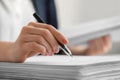 Woman signing documents at table in office, closeup. Space for text Royalty Free Stock Photo