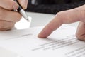 Woman signing a paper