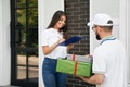 Woman signing paper and receiving boxes. Royalty Free Stock Photo