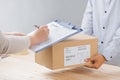 Woman signing receipt of delivery package, close up Royalty Free Stock Photo