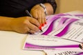 The woman signs the certificate at the office