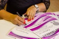 The woman signs the certificate at the office