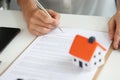 Woman signs home purchase agreement in office closeup Royalty Free Stock Photo