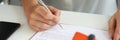 Woman signs home purchase agreement in office closeup Royalty Free Stock Photo