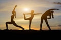 woman silhouette doing yoga outside the house in the evening