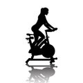 Woman silhouette on exercycle in spinning class Royalty Free Stock Photo