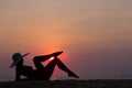 Woman silhouette with hat lying on sea background