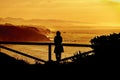 Woman silhouette having fun on the beach at the sunset time. Concept of summer vacation Royalty Free Stock Photo