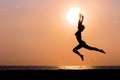 Woman silhouette jumping on sea background