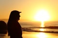 Woman silhouette looking forward at sunset