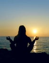 Woman silhouette making yoga