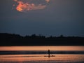 Woman silhouette on paddle board in the lake