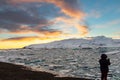 Woman in silhouette photographing the Glacier Lagoon in Iceland