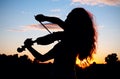 Woman silhouette playing violin