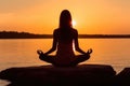 Woman Silhouette Practicing Yoga Pose and Meditation at Vibrant Sunset Ocean Beach extreme closeup. Generative AI Royalty Free Stock Photo