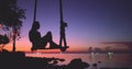 Woman silhouette relax swing sway, sea sunset sky Royalty Free Stock Photo