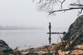 Woman silhouette on the river bank in the morning fog Royalty Free Stock Photo